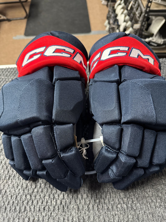 Pair of CCM hockey gloves on a textured surface